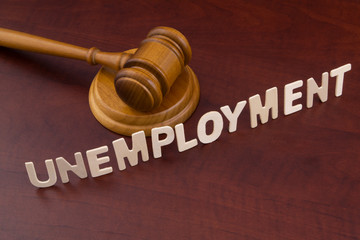 Unemployment and economics crisis concept, wooden judge gavel and word unemployment.