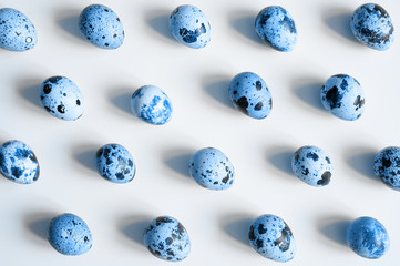 quail eggs on a white background. a regular pattern. toned classic blue color trend 2020 year