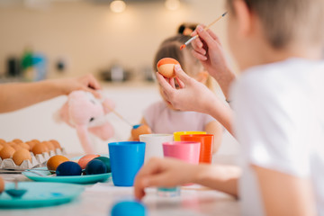 Family Easter Decoration Painting Eggs Mom with three kids