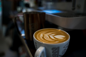 Barista makes beautiful latte art. Specialty coffee concept.