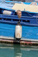 Buoy of a fishing boat with a mannequin head