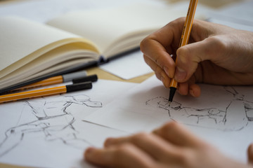 How to draw class of many figure drawing pencil and marker sketches. The artist worskspace with male and female drawings and pencils on the white paper, art, craft, creativity, inspiration, concepts