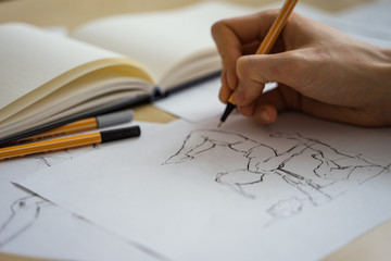 How to draw class of many figure drawing pencil and marker sketches. The artist worskspace with male and female drawings and pencils on the white paper, art, craft, creativity, inspiration, concepts