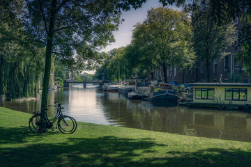 Relaxing view of a park with bikes near a canal in Amsterdam.