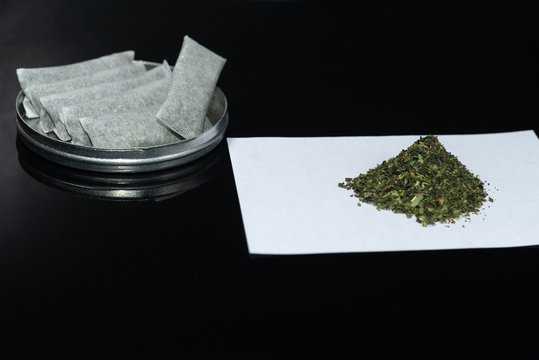 Box Snus - grated moistened powder and chewing tobacco. Close-up. Tobacco product