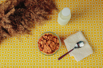 Cereals, spoon and milk bottle on the table. Healthy nutrition, healthy food on the table.