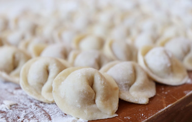 cooking Russian national dish of dumplings