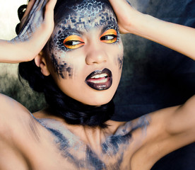 fashion portrait of pretty young woman with creative make up like a snake, halloween concept