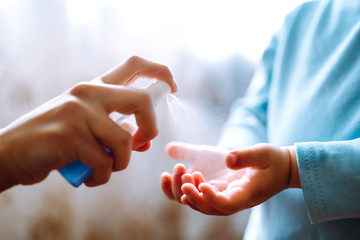 Hands with sanitizer antiseptic. Mother and child using sanitize antiseptic for hand coronavirus protection.Hygiene concept. Prevent spread of germs and bacteria and avoid infections coronavirus. - obrazy, fototapety, plakaty