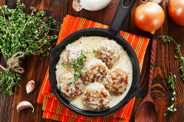 Meatballs with rice in a creamy sauce