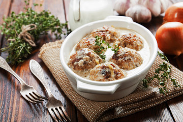 Meatballs with rice in a creamy sauce