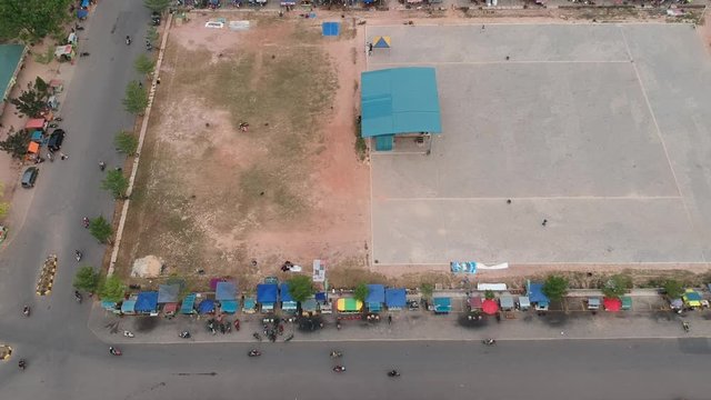Aerial view on batam city, one-way street is crossed by culinary motorcycle riders on the roadside.batam island,indonesia