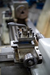 Abandoned machine metalworking lathe in a factory closing due to the pandemic virus