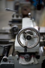 Abandoned machine metalworking lathe in a factory closing due to the pandemic virus