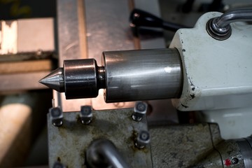 Abandoned machine metalworking lathe in a factory closing due to the pandemic virus