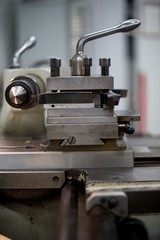 Abandoned machine metalworking lathe in a factory closing due to the pandemic virus