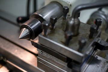 Abandoned machine metalworking lathe in a factory closing due to the pandemic virus