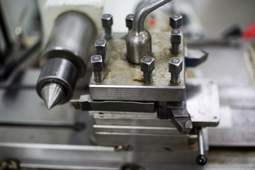 Fototapeta na wymiar Abandoned machine metalworking lathe in a factory closing due to the pandemic virus