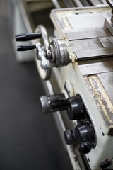 Abandoned machine metalworking lathe in a factory closing due to the pandemic virus