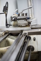 Abandoned machine metalworking lathe in a factory closing due to the pandemic virus