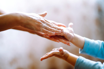 Mom helps her chaild wash her hands. They are rubbing their hands together creating foam with the soap. Hygiene concept. Prevent spread of germs and bacteria and avoid infections coronavirus.