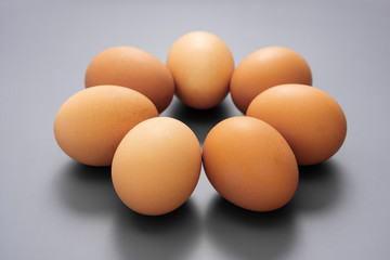 Raw eggs isolated on grey background, protein food.