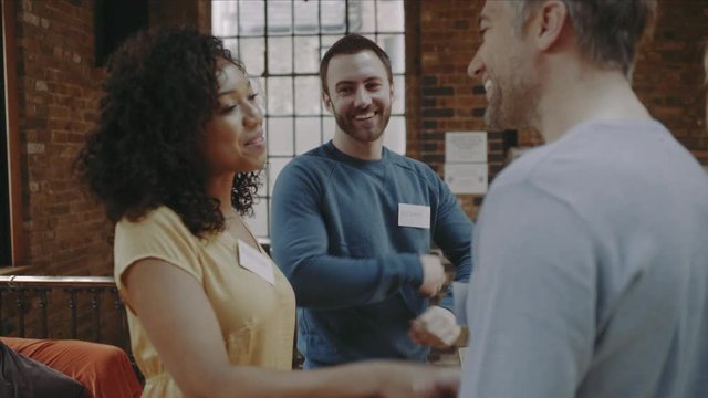 Group meeting at networking event and shaking hands