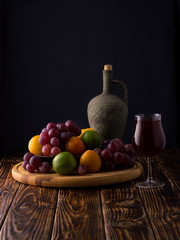 red wine with fruits on a wooden table.