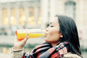 young woman drinking orange juice