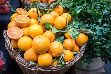 Oranges on the counter of farmers market. Half cut orange