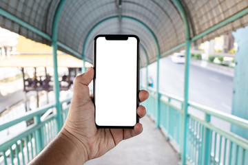 Asian man holding phone mock up left frame show screen mobile at overpass isolated display for insert screen
