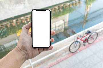 Asian man holding phone mock up left frame take photo bicycle on the overpass top street isolated display for insert screen
