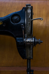 Vintage sewing machine. Retro. History of sewing. Cover, elements and details of a sewing machine close-up. Macro photo.
