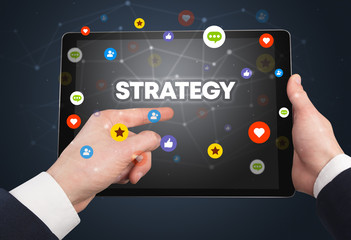 Close-up of a touchscreen with STRATEGY inscription, social networking concept