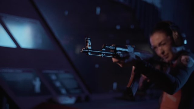 girl shoots from a machine gun