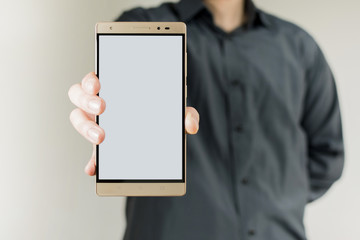 Young man with blank vertical phablet.