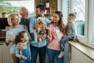 Happy multi-generation family with a dog at home.