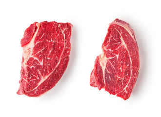 Two slices of frozen beef meat for steak on a white background.