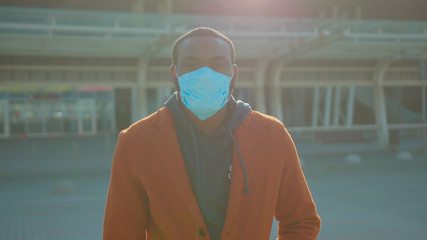 African American man wearing Protective Face Mask to avoid disease COVID-19 coronavirus infection...