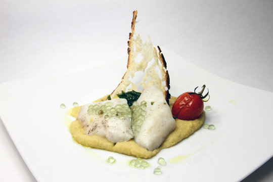 Mullet fillet on cream of grass peas, nettles and its non-caviar with mint
