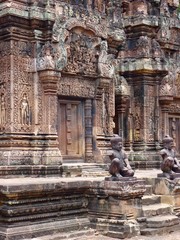 Ruins of Angkor, temple of Banteay Srei, stone statues of guardians before pyramids, Angkor Wat, Cambodia
