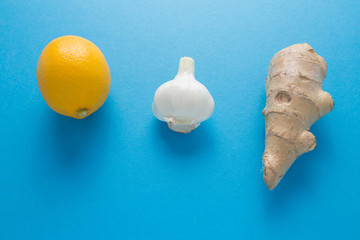 Lemon garlic ginger on a blue background. The body's natural defense against disease.