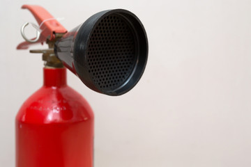 Red Fire Extinguisher in Front of Grey Background