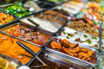 Traditional Asian dishes sold in a food court in Singapore