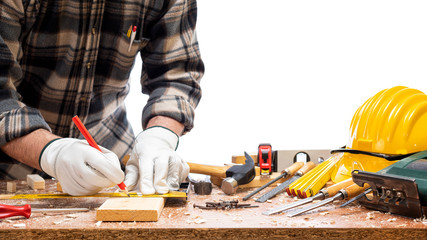 Close-up. Carpenter with his hands protected by gloves with pencil and carpenter's square draw the...
