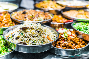 Traditional Asian dishes sold in a food court in Singapore