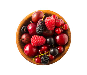 Top view. Fruits and berries in bowl on white background. Mixed fruits with copy space for text. Mixed berries isolated on a white background. Various fresh summer.Fruits and berries isolated on white