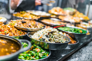 Traditional Asian dishes sold in a food court in Singapore
