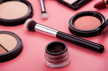 cosmetic products on a pink background