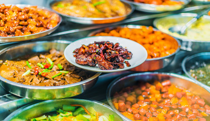 Traditional Asian dishes sold in a food court in Singapore
